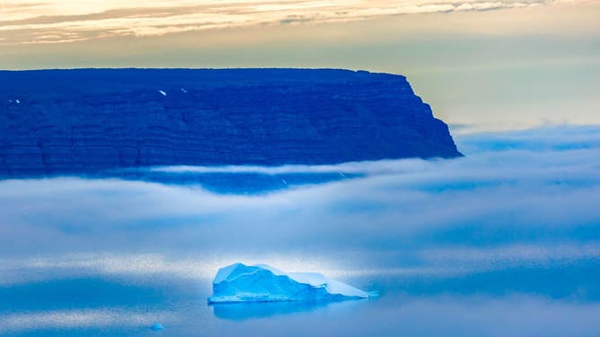 Icebergs seen through the fog float in the Baffin Bay near Pituffik, Greenland on July 20, 2022 as captured on a NASA Gulfstream V plane while on an airborne mission to measure melting Arctic sea ice.