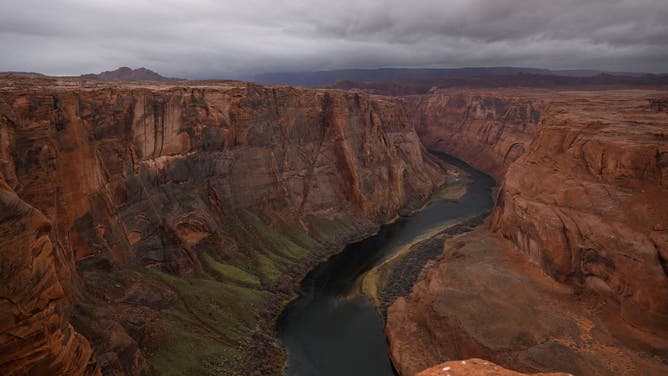 Dark skies move over the Colorado River at Horseshoe Bend on January 1, 2023 in Page, Arizona.