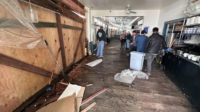 Damages inside Zelda's on the Beach. Wood now covers up the walls that were destroyed in the storm.