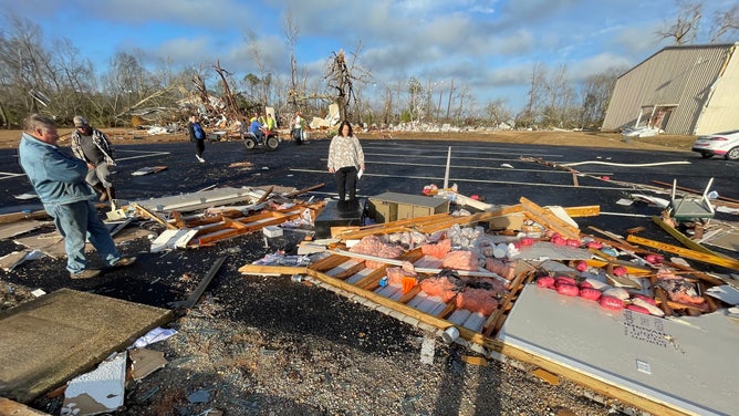 Members of the Wadsworth Baptist Church congregation look on at the devastation caused by the tornado.
