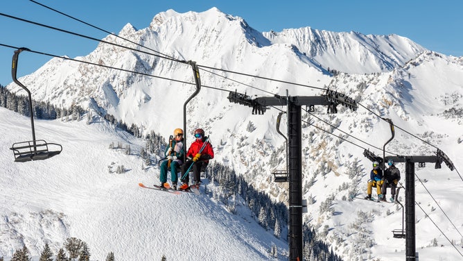 Skiers on a lift in Alta Ski Area in Utah.
