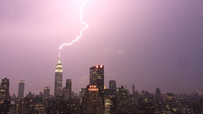 FILE - Lightning strikes the Empire State Building on July 15, 2014 in New York City.