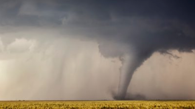 A stove pipe tornado cuts its way through a field in Minneola, Kansas, 24 May 2016.