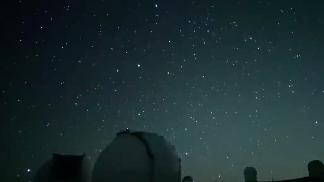 A stars sparkle over the Subaru Telescope (domes at the bottom of the frame) on Hawaii's Mauna Kea volcano summit.