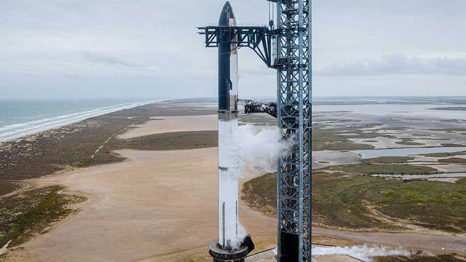 SpaceX's Starship 24 test spaceship and Super Heavy Booster 7 at the company's Starbase launch tower in Texas ahead of a launch wet dress rehearsal. 
