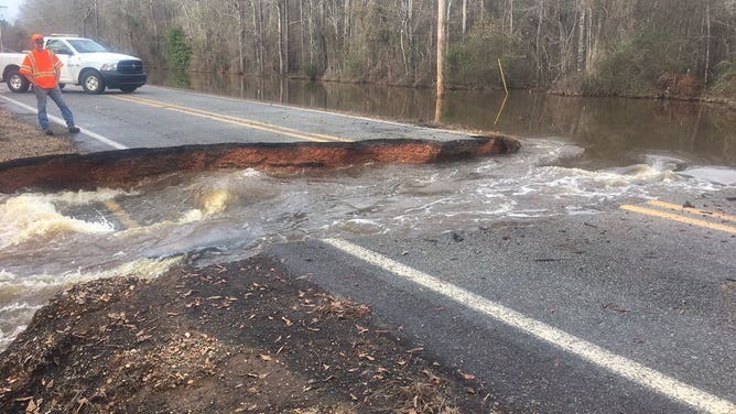 Highway 203 near Hampton, Arkansas cut in half by fast moving water. 