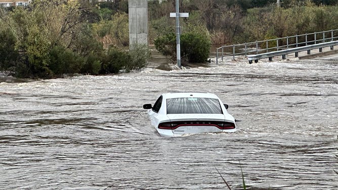 Car trapped in San Diego, California, floodwater.