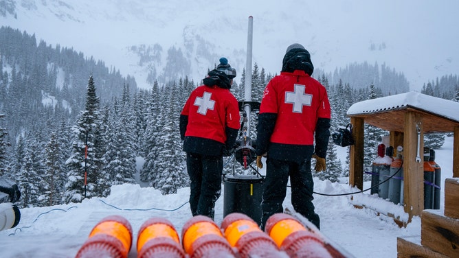 Members of ski patrol launching explosives into the mountain.