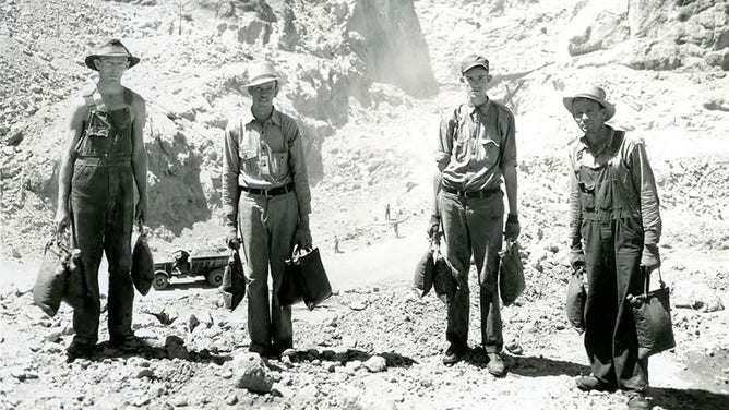 Workmen at isolated points away from drinking fountains are supplied by desert water bags. This picture shows a crew of "water boys" at the Arizona spillway. July 14, 1932.