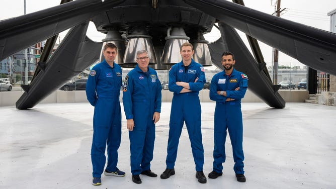The four SpaceX Crew-6 members pose for a portrait underneath a Falcon 9 rocket booster at the company's headquarters in Hawthorne, California. 
