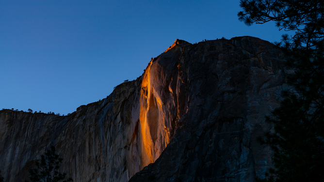FILE - General views of the Yosemite Firefall natural phenomenon at Horsetail Fall ending in a pinkish hue on February 24, 2021 in Yosemite, California.