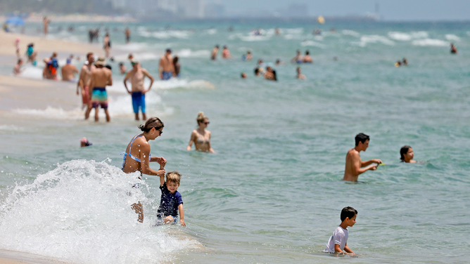 FILE - Beachgoers are shown on Fort Lauderdale Beach on July 14, 2022, in Florida.