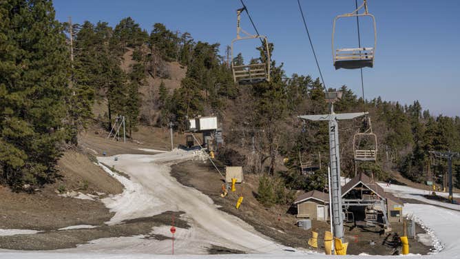 Snow melts around chair lifts at Mountain High Resort in Wrightwood, California, on April 6, 2022.