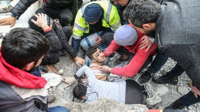 HATAY, TURKIYE - FEBRUARY 06: Mehmet Emin Ataoglu rescued under the rubble of 6-storey-building after 7.7 magnitude earthquake hits Iskenderun district of Hatay, Turkiye on February 06, 2023. Disaster and Emergency Management Authority (AFAD) of Turkiye said the 7.7 magnitude quake struck at 4.17 a.m. (0117GMT) and was centered in the Pazarcik district in Turkiyeâs southern province of Kahramanmaras. Gaziantep, Sanliurfa, Diyarbakir, Adana, Adiyaman, Malatya, Osmaniye, Hatay, and Kilis provinces are heavily affected by the quake. (Photo by Murat Sengul/Anadolu Agency via Getty Images)