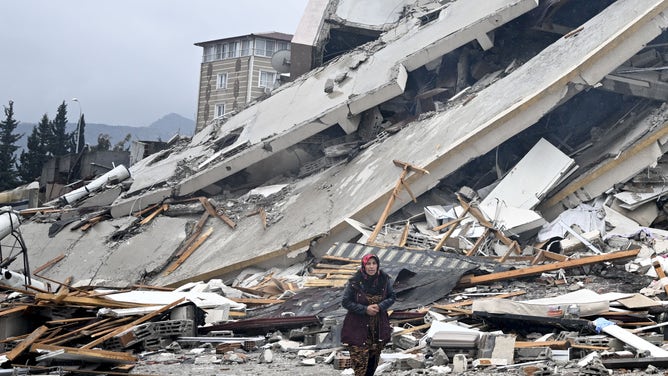 HATAY, TURKIYE - FEBRUARY 06: A view of a collapsed building in Hatay, Turkiye after 7.7 and 7.6 magnitude earthquakes hits Turkiye's Hatay, on February 06, 2023. Disaster and Emergency Management Authority (AFAD) of Turkiye said the 7.7 magnitude quake struck at 4.17 a.m. (0117GMT) and was centered in the Pazarcik district and 7.6 magnitude quake struck in Elbistan district in the province of Kahramanmaras in the south of Turkiye. Gaziantep, Sanliurfa, Diyarbakir, Adana, Adiyaman, Malatya, Osmaniye, Hatay, and Kilis provinces are heavily affected by the earthquakes. (Photo by Ercin Erturk/Anadolu Agency via Getty Images)
