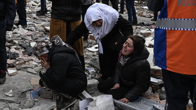 DIYARBAKIR, TURKIYE - FEBRUARY 06: A woman cries as personnel conduct search and rescue operations in Diyarbakir, Turkiye after 7.7 and 7.6 magnitude earthquakes hits Turkiye's Kahramanmaras, on February 06, 2023. Disaster and Emergency Management Authority (AFAD) of Turkiye said the 7.7 magnitude quake struck at 4.17 a.m. (0117GMT) and was centered in the Pazarcik district and 7.6 magnitude quake struck in Elbistan district in the province of Kahramanmaras in the south of Turkiye. Gaziantep, Sanliurfa, Diyarbakir, Adana, Adiyaman, Malatya, Osmaniye, Hatay, and Kilis provinces are heavily affected by the earthquakes. (Photo by Esra Hacioglu Karakaya/Anadolu Agency via Getty Images)