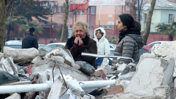KAHRAMANMARAS, TURKIYE - FEBRUARY 06: Citizens wait near destroyed apartment building as search and rescue operations continue in Kahramanmaras after 7.7 and 7.6 magnitude earthquakes hit Turkiye's Kahramanmaras, on February 06, 2023. Disaster and Emergency Management Authority (AFAD) of Turkiye said the 7.7 magnitude quake struck at 4.17 a.m. (0117GMT) and was centered in the Pazarcik district and 7.6 magnitude quake struck in Elbistan district in the province of Kahramanmaras in the south of Turkiye. Gaziantep, Sanliurfa, Diyarbakir, Adana, Adiyaman, Malatya, Osmaniye, Hatay, and Kilis provinces are heavily affected by the earthquakes. (Photo by Serhat Zafer/Anadolu Agency via Getty Images)