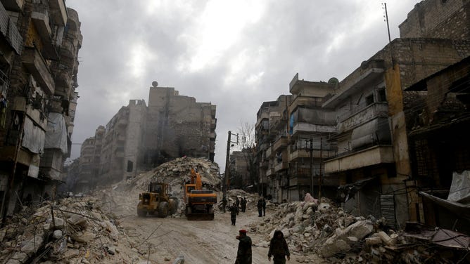 EDITORS NOTE: Graphic content / Syrian rescue teams search for victims and survivors at the rubble a collapsed building in the city of Aleppo following a deadly earthquake on February 6, 2023. - The Syrian government urged the international community to come to its aid after more than 850 people died in the country following a 7.8-magnitude earthquake in neighbouring Turkey. (Photo by LOUAI BESHARA / AFP) (Photo by LOUAI BESHARA/AFP via Getty Images)