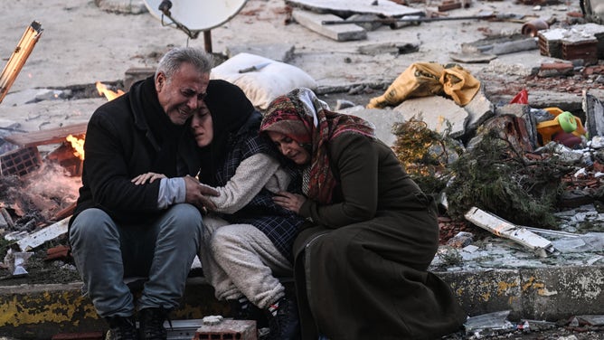 ADIYAMAN, TURKIYE - FEBRUARY 07: Citizens mourn among rubbles after multiple earthquakes jolt Turkiye's Southeastern provinces, in Adiyaman, Turkiye on February 07, 2023. Early Monday morning, a strong 7.7 earthquake, centered in the Pazarcik district, jolted Kahramanmaras and strongly shook several provinces, including Gaziantep, Sanliurfa, Diyarbakir, Adana, Adiyaman, Malatya, Osmaniye, Hatay, and Kilis. Later, at 13.24 p.m. (1024GMT), a 7.6 magnitude quake centered in Kahramanmaras' Elbistan district struck the region. (Photo by Esra Hacioglu Karakaya/Anadolu Agency via Getty Images)