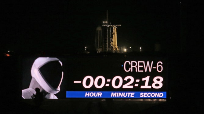 Shot of countdown clock in the foreground and the SpaceX Crew-6 in the background on the early morning of Feb. 27, 2023.