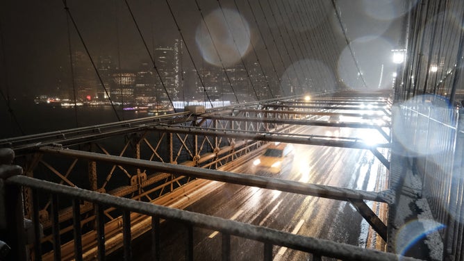NEW YORK, NEW YORK - FEBRUARY 27: Snow falls as vehicles travel across the Brooklyn Bridge on February 27, 2023 in New York City. Parts of northern New York City could see up to five inches of snow by morning in what would be the first real snowfall of the winter.
