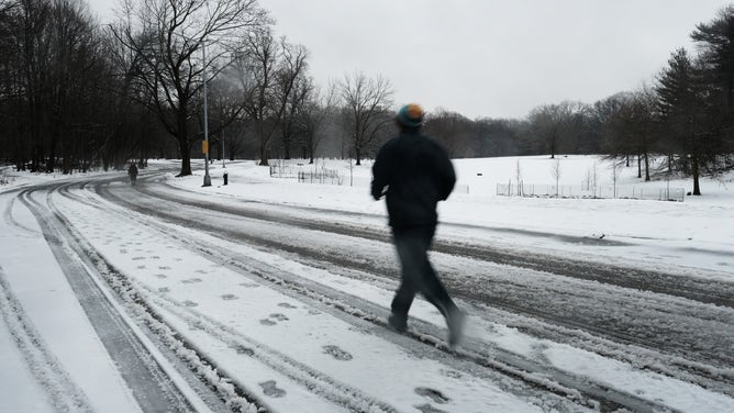 NEW YORK, NEW YORK - FEBRUARY 28: People run through Brooklyn's Prospect Park on a snowy morning over on February 28, 2023 in New York City. New York City and much of the Northeast received overnight snow, sleet and rain in what is first real snowfall of the winter for many communities.