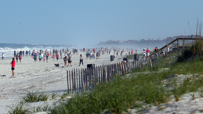 FILE - People crowded the beaches in its first open hour on April 17, 2020 in Jacksonville Beach, Fl.