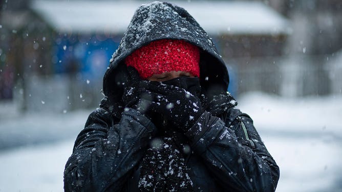 Woman bundles up in cold weather