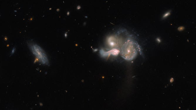 In the middle of the image, the three galaxies can be seen converging.