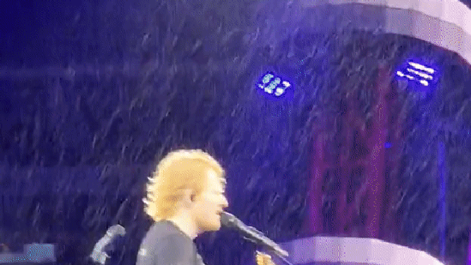 Ed Sheeran performs in rain