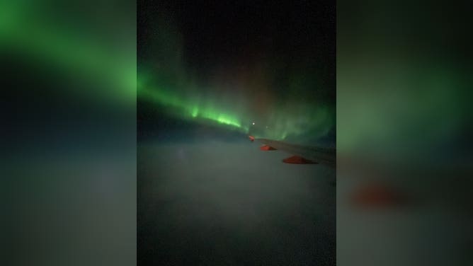 Northern Lights over the wing of easyJet flight from Reykjavik, Iceland to Manchester, U.K. February 27, 2023.