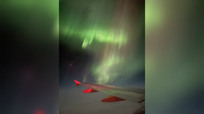Northern Lights over the wing of easyJet flight from Reykjavik, Iceland to Manchester, U.K. February 27, 2023.