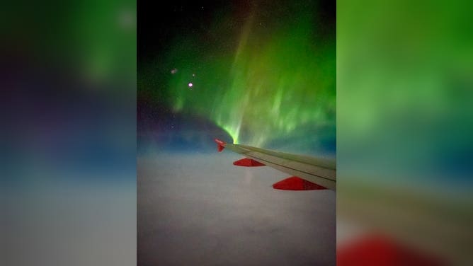 Northern Lights over the wing of easyJet flight from Reykjavik, Iceland to Manchester, U.K. February 27, 2023.