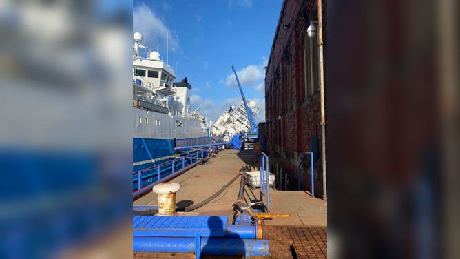 Large Research Vessel Tips Onto Scotland Dock