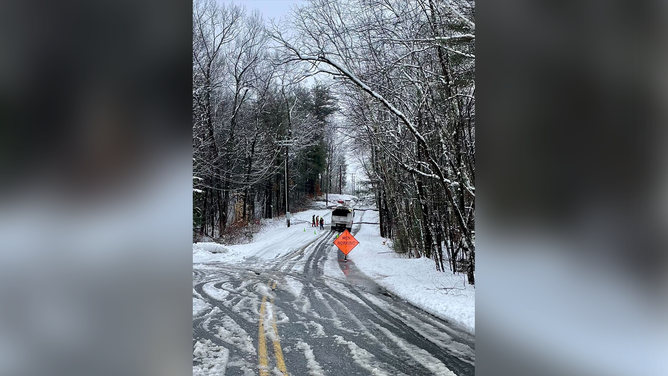 Utility crews are seen repairing downed power lines in Massachusetts.