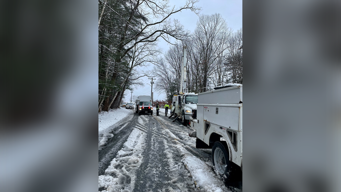 Utility crews are seen repairing downed power lines in Massachusetts.