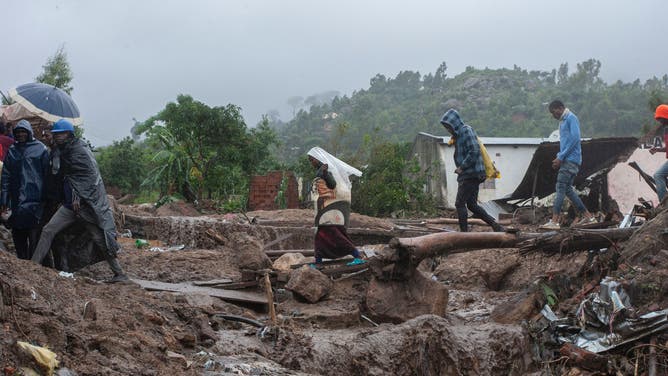 Residents in Chimwankhunda, Malawi try to save their belongings from floods caused by Cyclone Freddy. March 14, 2023.