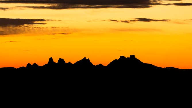 The sun sets beyond the Castle Mountains within Avi Kwa Ame on Feb. 13, 2023, in Boulder City, Nevada. 