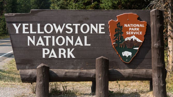 The wooden entrance sign to Yellowstone National Park