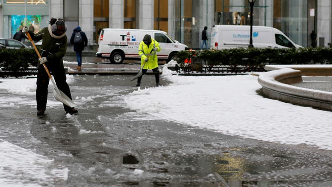 People shoveling snow in Northeast