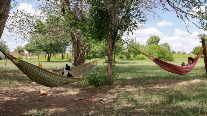 A couple relaxing in hammocks at the El Cosmico campsite in Marfa, Texas.