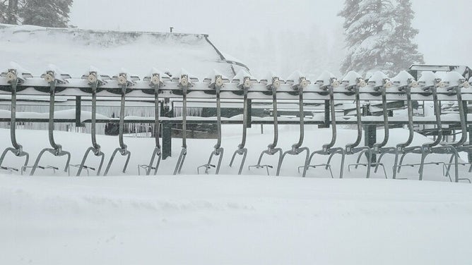 Chairs of ski lift buried in the snow.