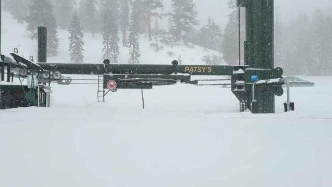 Chairs of ski lift buried in the snow.