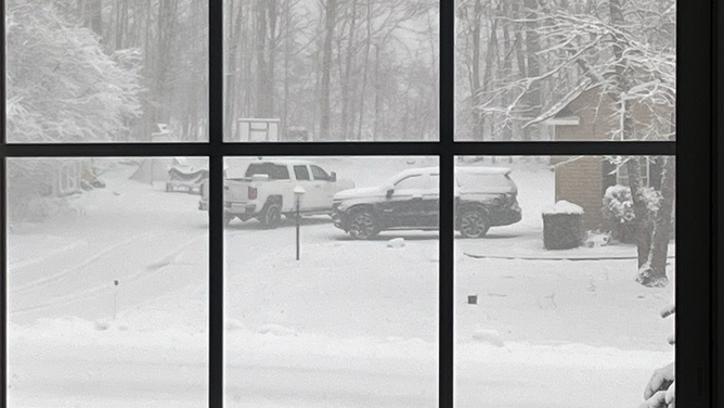 Snow is seen out the window of a home in Marcellus, New York, on Tuesday, March 14, 2023.