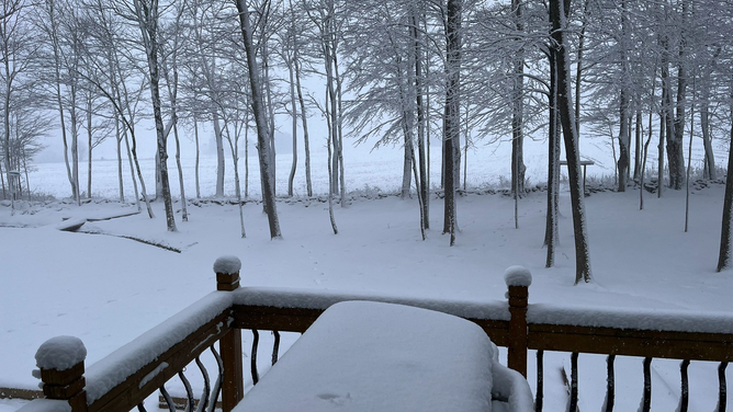 Several inches of snow are seen off the deck of a home in Marcellus, New York, on Tuesday, March 14, 2023.