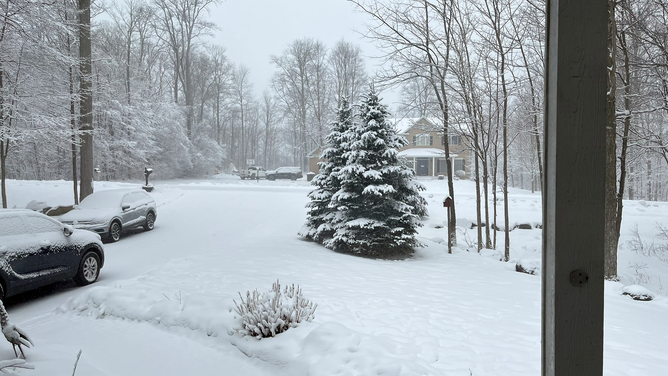 Heavy snow is seen from a home in Marcellus, New York, on Tuesday, March 14, 2023.