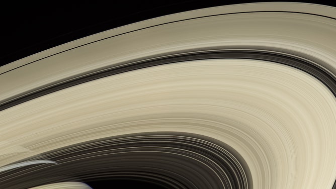 Saturn's rings are made mostly of particles of water ice that range in size from smaller than a grain of sand to as large as mountains. The ring system extends up to 175,000 miles (282,000 kilometers) from the planet, but for all their immense width, the rings are razor-thin, about 30 feet (10 meters) thick in most places.