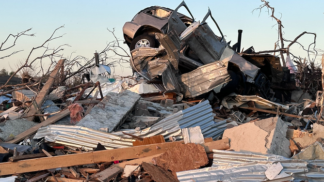 A car is seen on top of a debris pile in Rolling Fork, Mississippi.