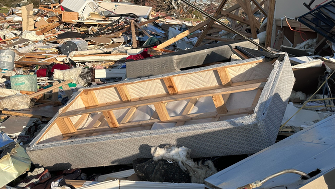 A bed foundation is seen laying among debris from a destroyed home after a tornado in Rolling Fork, Mississippi, on Friday, March 24, 2023.