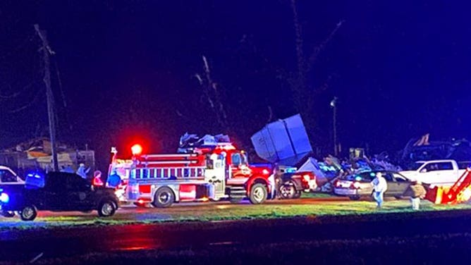 Emergency vehicle line a road in Silver City, Mississippi, after a tornado hit the town March 24, 2023.